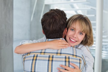 Loving young woman embracing man