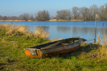 Old rowboat on the shore of a river