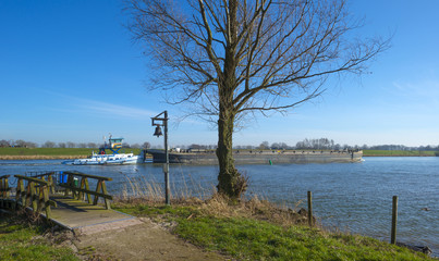 Barge sailing on a sunny river in winter