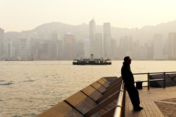 Man standing along Victoria Harbor