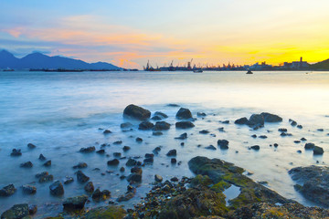 Fototapeta premium Sunset along coast with sea stones