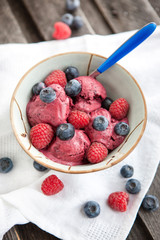 Berry ice cream decorated with fresh blueberries and raspberries