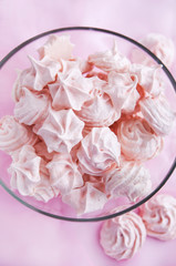 Pink meringues in a glass bowl