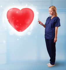 Young nurse healing a red heart