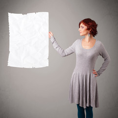 Young girl holding crumpled white paper copy space