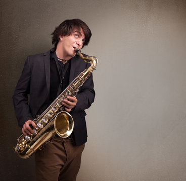 Young musician playing on saxophone