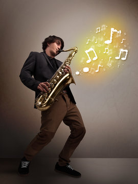 Handsome musician playing on saxophone with musical notes