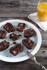 chocolate and pears cake on plate and orange juice