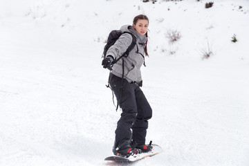 Female snowboarder is skiing