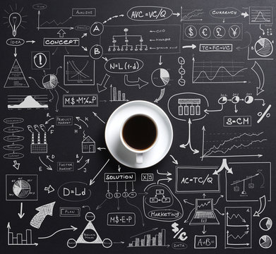 Cup of coffee over the black background with graphs