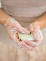 Closeup on young woman hands with soap