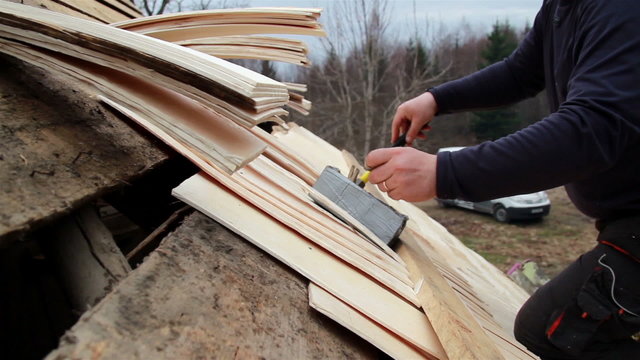 Roofer wearing work clothes cedar wooden shingle shake