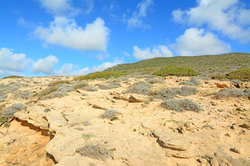 rocky hill under clouds