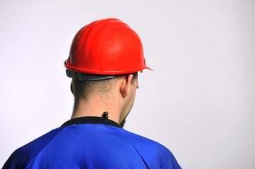Worker wearing a construction site red helmet