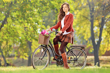 Beautiful female on her bicycle in a park