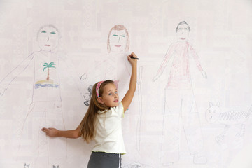 Girl draws on the wall