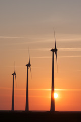 Fototapeta na wymiar Silhouette of a Windfarm during sunset