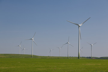 Windfarm with a clear blue sky producing alternative energy