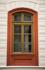 Fototapeta na wymiar Window red frames on a facade