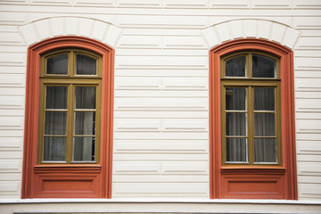 Fototapeta na wymiar Two window red frames on a facade