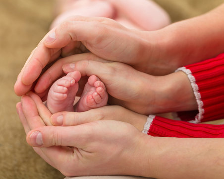 Baby foots in parents hands