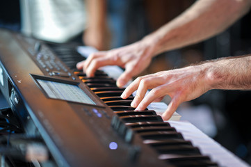 Obraz premium Closeup shot of male hands playing the piano. Human hands