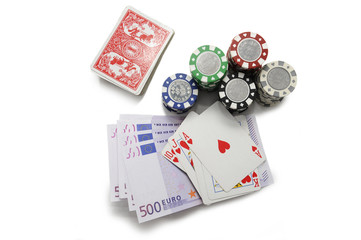 Royal flush poker hand with poker chips and euro bills isolated