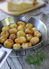 fried potatoes in a pan with cheese and dill