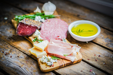 Chopping board of Assorted Cured Meats, Cheese and Honey with ro