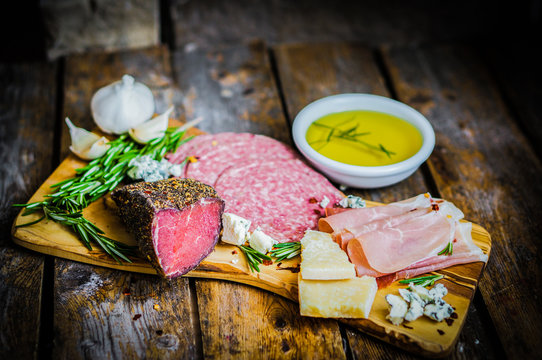 Chopping board of Assorted Cured Meats, Cheese and Honey with ro