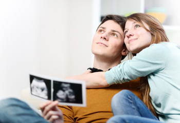 Beautiful couple imagines the future of their unborn child with