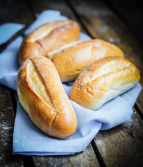 Bread rolls on rustic wooden background
