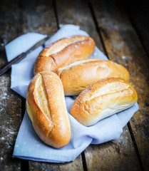 Bread rolls on rustic wooden background