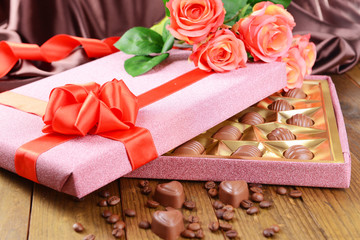 Delicious chocolates in box with flowers