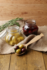 Tasty olives on wooden table