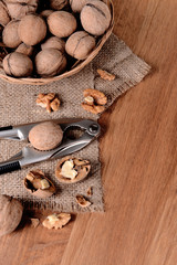 Nutcracker with walnuts on wooden background