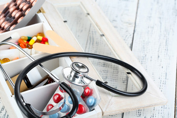 Medical pills,stethoscope,  ampules in wooden box,