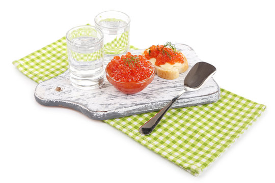 Red caviar in bowl and vodka