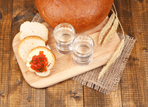 Composition with glasses of vodka  bread and red caviar