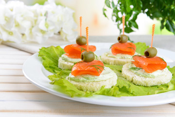 Delicious canapes on table close-up