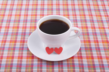 Cup of coffee and two hearts.