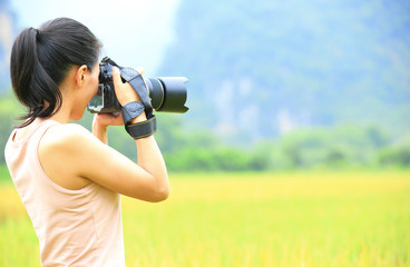 woman photographer taking photo in the rice paddy
