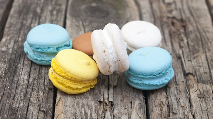 Colorful macaroons, delicious French pastries, stacked on table.