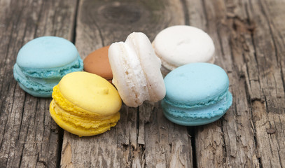 Colorful macaroons, delicious French pastries, stacked on table.