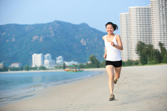 fitness  young woman running seaside