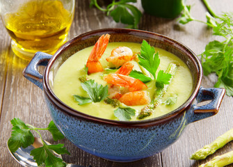 Cream of asparagus soup with shrimp.