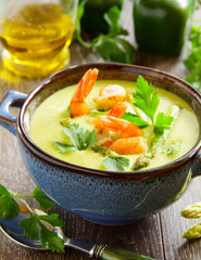 Cream of asparagus soup with shrimp.