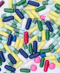 Colorful pills on white background