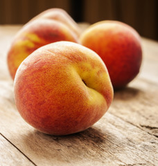 Fototapeta na wymiar peaches in wooden background