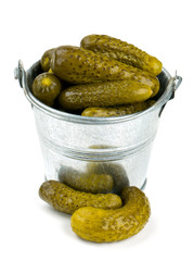pickled cucumbers in a metal bucket isolated on white